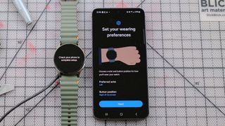 Samsung Galaxy Watch 7 next to a Samsung Galaxy S24 smartphone showing the screen where users can select their watch wearing preferences