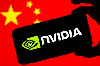CHONGQING, CHINA - JULY 17: In this photo illustration, a smartphone displaying the logo of Nvidia Corporation (NASDAQ: NVDA), a leading American semiconductor and artificial intelligence company, is held in front of a screen showing the national flag of China on July 17, 2025 in Chongqing, China. (Photo illustration by Cheng Xin/Getty Images)