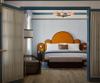 Bedroom with orange headboard in The Georgian Hotel