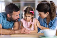 Parents either side of little girl, validating her feelings