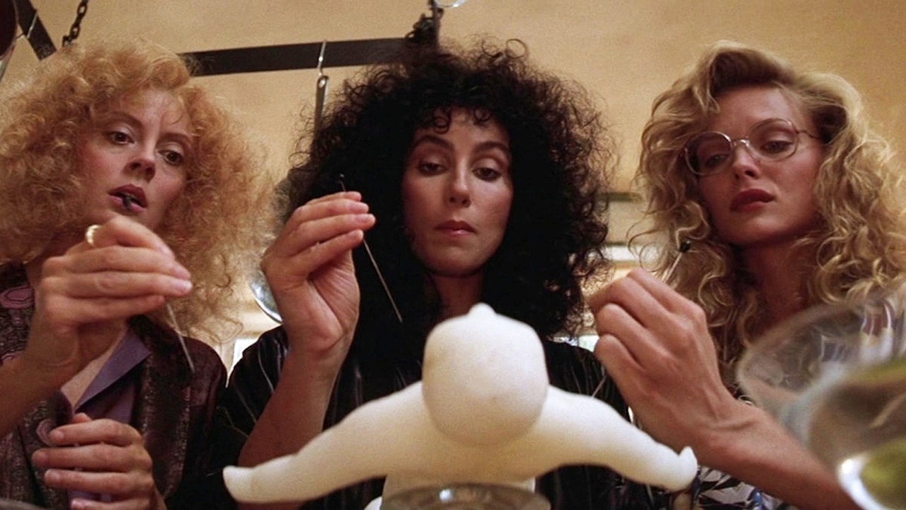Susan Sarandon, Cher, and Michelle Pfeiffer as they sew a vudu doll in 'The Witches of Eastwick'