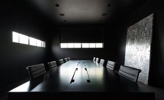 All-black conference room with black table , chairs