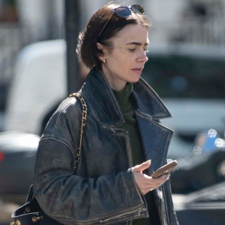 Lily Collins wearing an oversize leather jacket with a Chanel bag