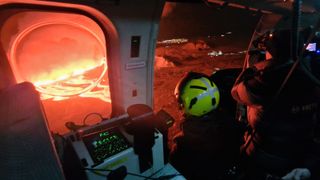 Researchers look at the eruption from a helicopter