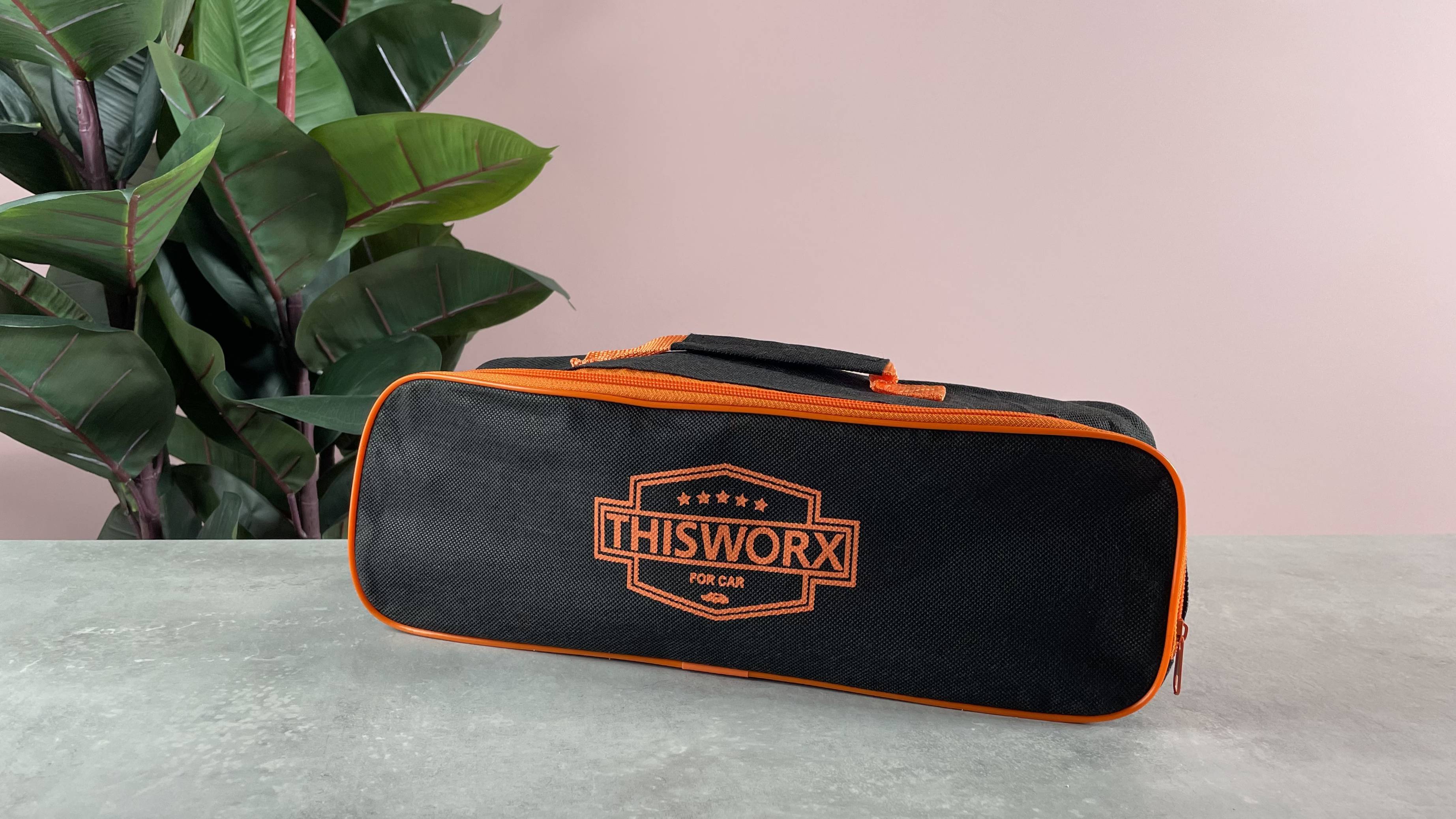 The gray stone has a black and orange storage bag on the surface, with this worx printed on the front.