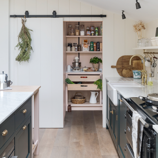 Blue country-style kitchen with island and butcher's table