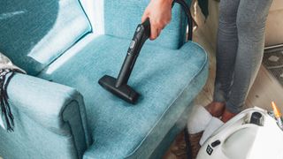 cleaning an armchair with a vaccum