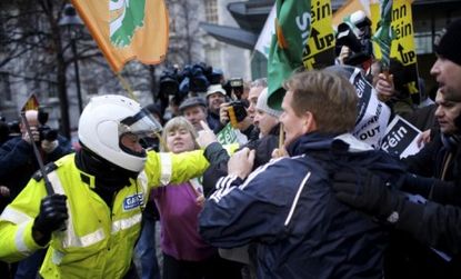 Irish police officers clash with protesters of the multi-billion EU bailout.
