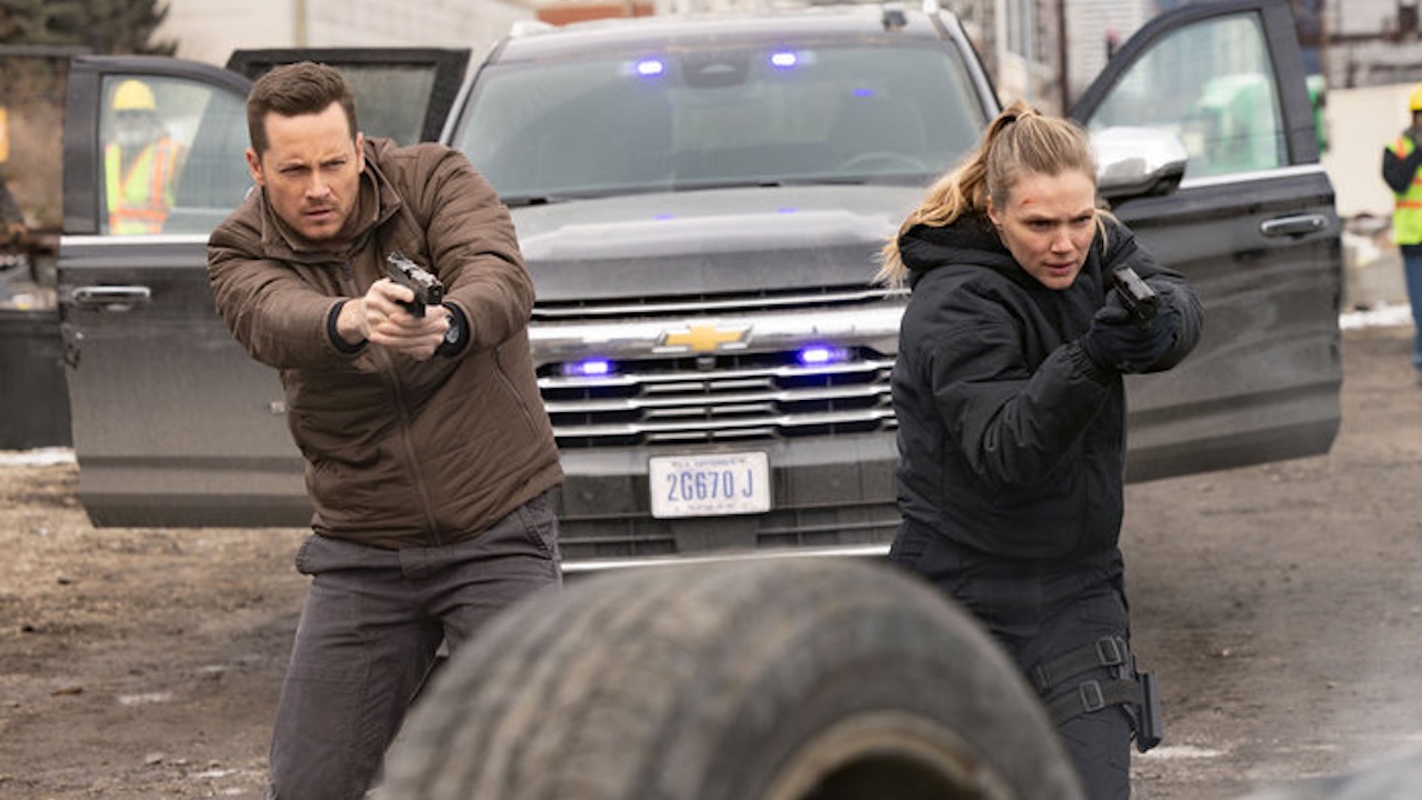 Halstead and Upton holding a suspect at gunpoint in One Chicago's 2026 crossover event