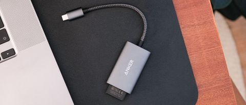 Anker PowerExpand+ 2-in-1 SD 4.0 Card Reader on a black leather mat