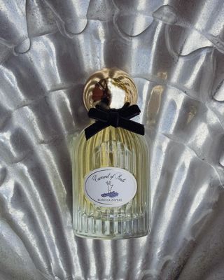 Marissa Zappas Carnival of Souls perfume bottle on a pearlescent background