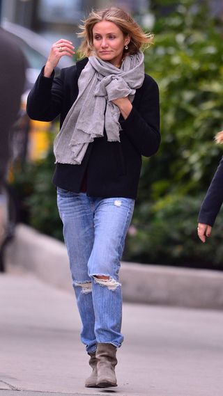 Cameron Diaz wearing ripped jeans, a scarf and pair of suede boots in 2014