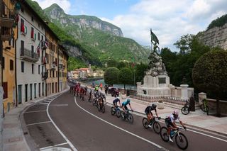 The pack of riders cycles through the town of Valstagna during the seventeenth stage of the Giro dItalia 2023 cycling race 197 km between Pergine Valsugana and Caorle near Venice on May 24 2023 Photo by Luca Bettini AFP Photo by LUCA BETTINIAFP via Getty Images
