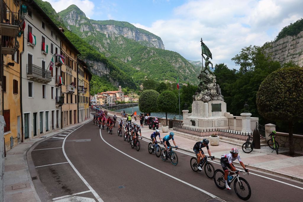 The pack of riders cycles through the town of Valstagna during the seventeenth stage of the Giro dItalia 2023 cycling race 197 km between Pergine Valsugana and Caorle near Venice on May 24 2023 Photo by Luca Bettini AFP Photo by LUCA BETTINIAFP via Getty Images