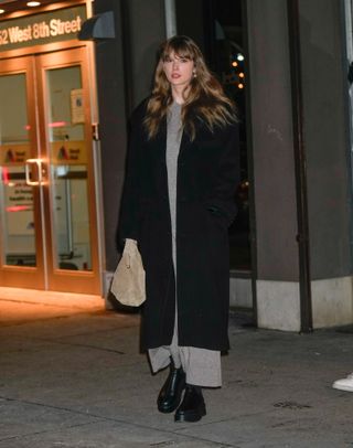 taylor swift in a cashmere dress and boots by the row