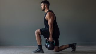 A man doing kettlebell lunges