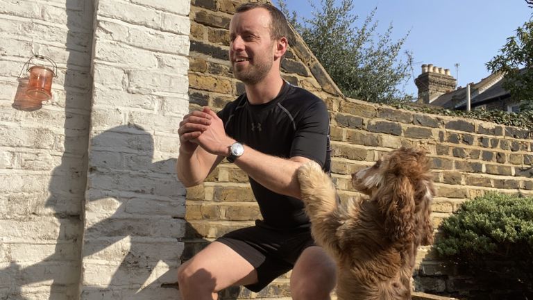James Frew doing a HIIT workout with his dog nearby