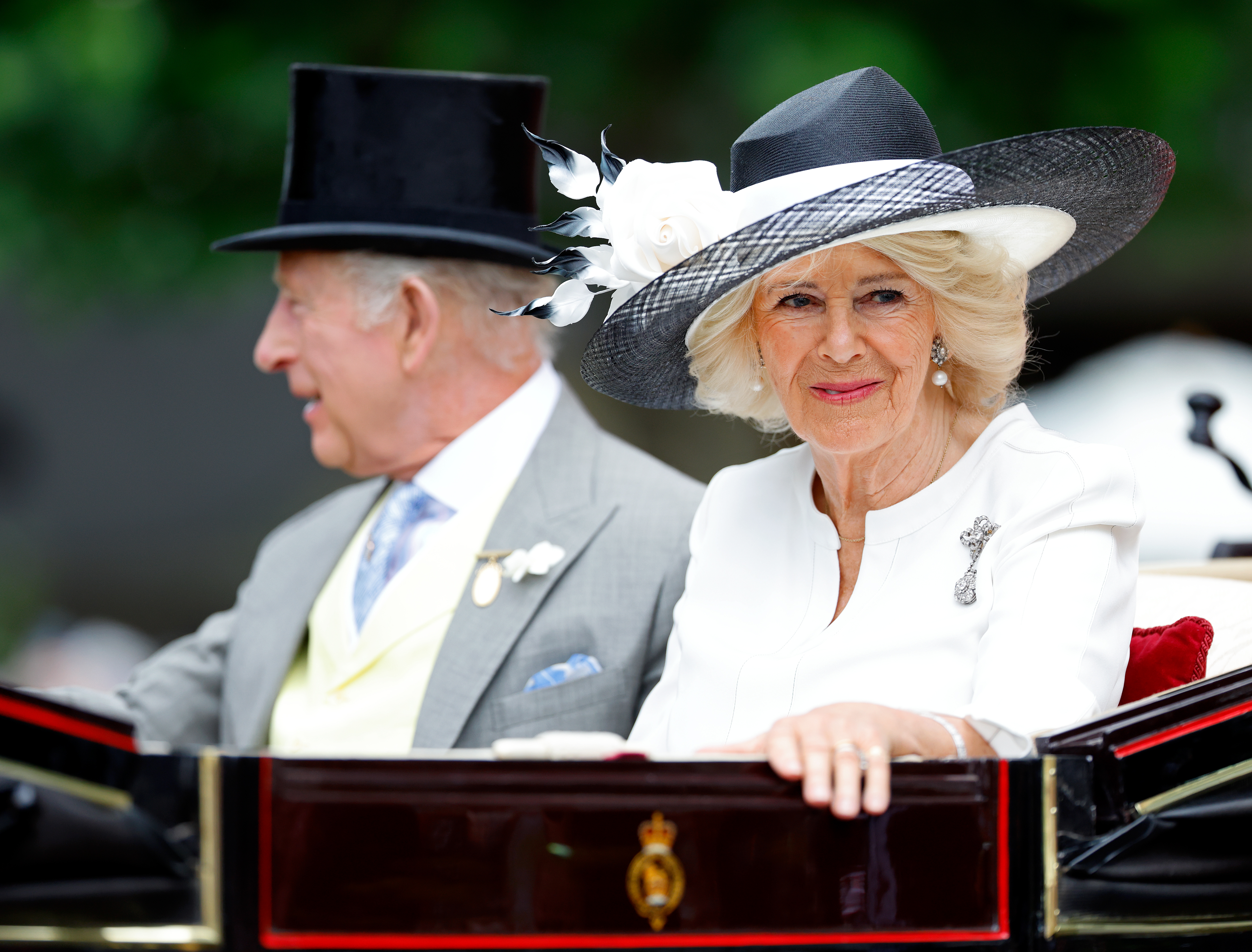 King Charles and Queen Camilla riding in a carriage at Royal Ascot