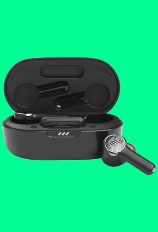 JBL Quantum TWS earbuds on greenbackground