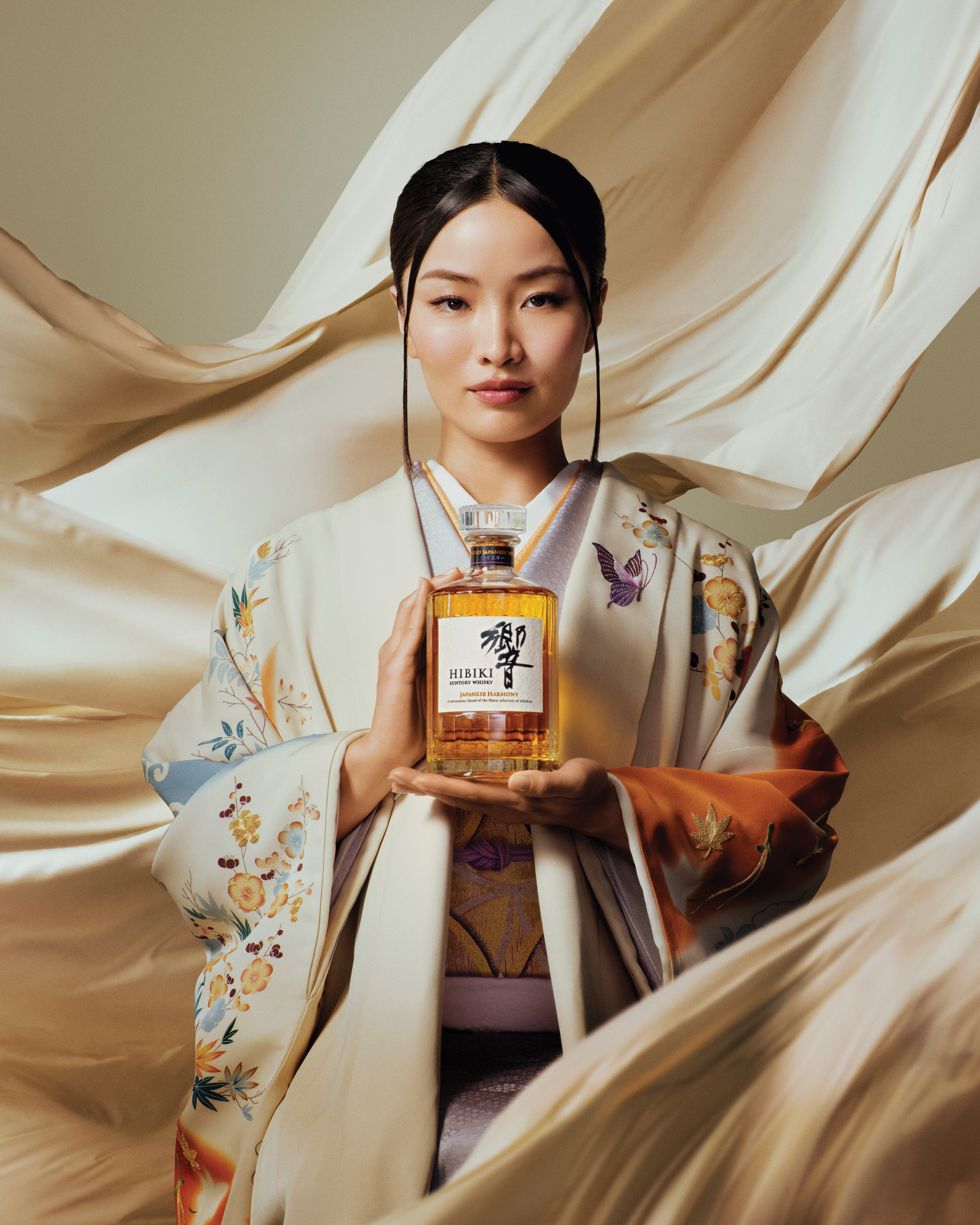 Woman holds whisky bottle