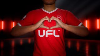 A footballer holding their hands in a heart shape.