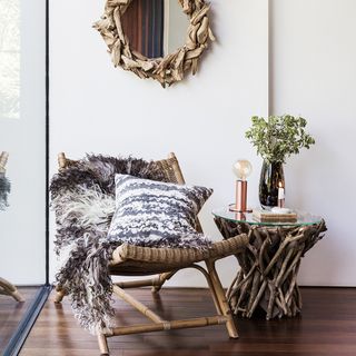 room with relaxing cane chair and antique wall mirror