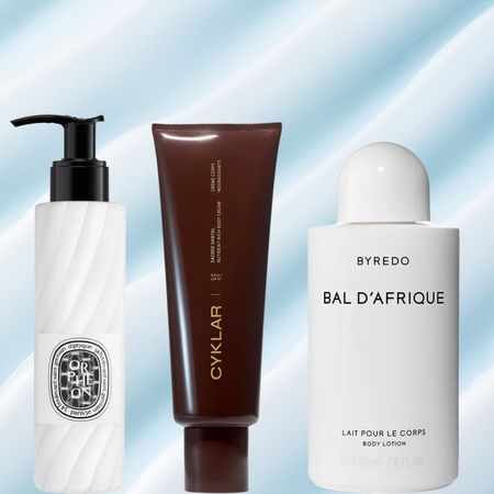 A woman with an off-the-shoulder top next top three bottles of lotion. They are all in front of a swatch of lotion background.