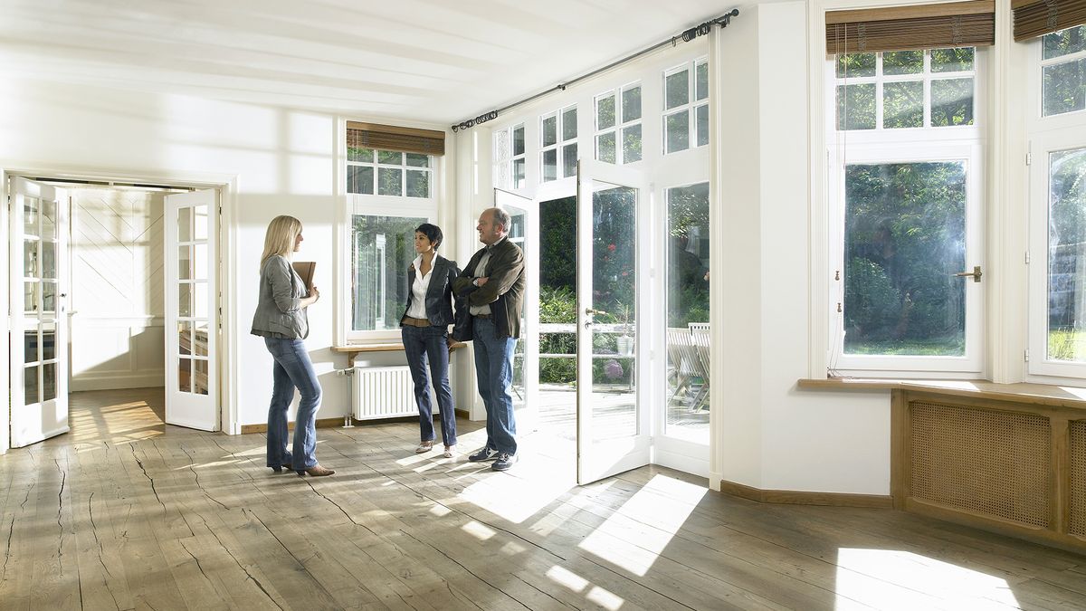 real estate agent showing clients around a house