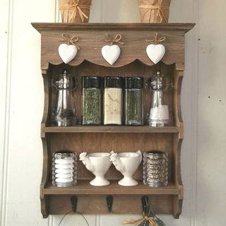 Small Shabby Chic Wooden Shelf Unit with salt, pepper and spice shakers and heart-shaped ornaments hanging