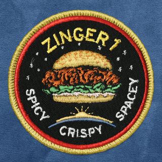 A mission patch designed by Kentucky Fried Chicken for a promotional campaign that will place a chicken sandwich on a high-altitude balloon.