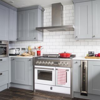 white wall kitchen with hob and chimney