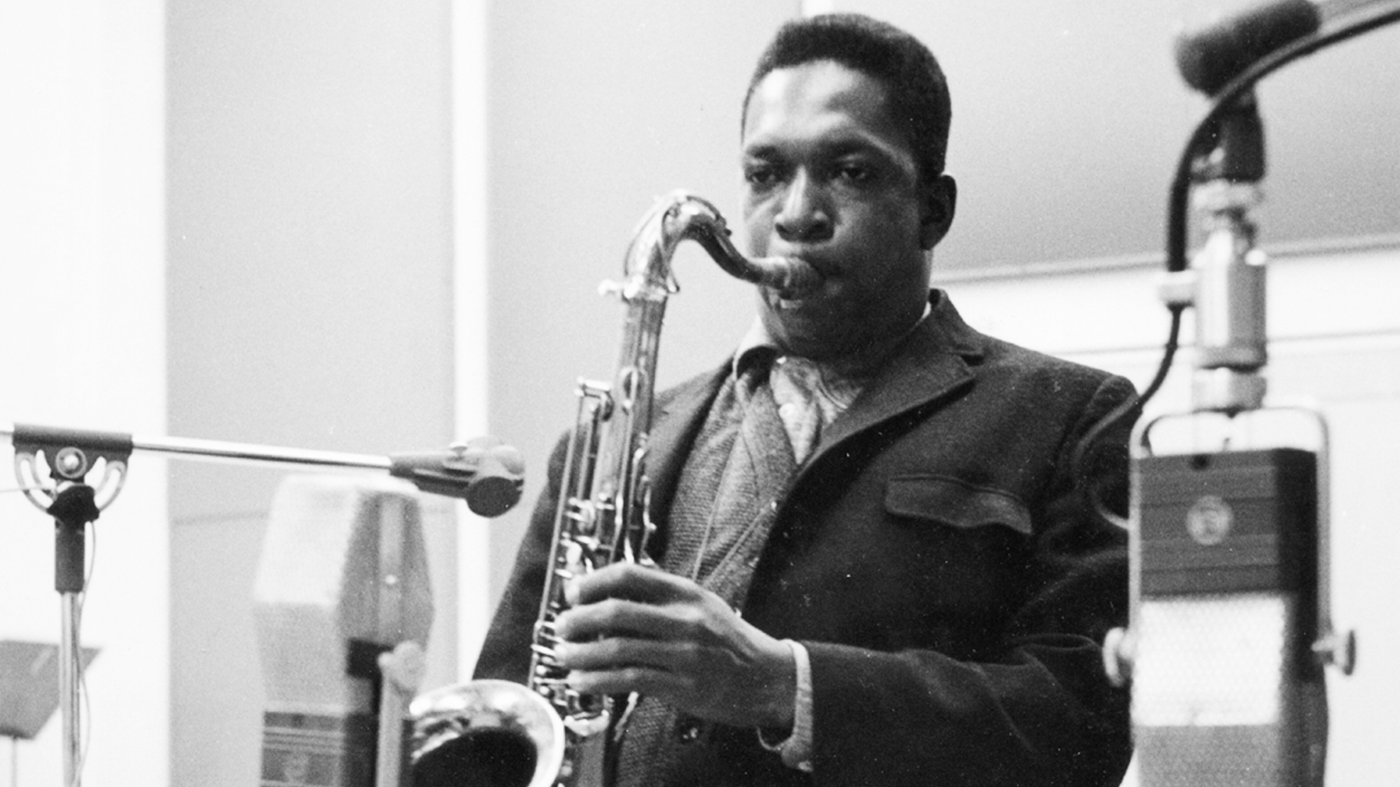 John Coltrane (1926 - 1967) playing his tenor saxophone during an Impulse Records recording session in New York, early 1960s