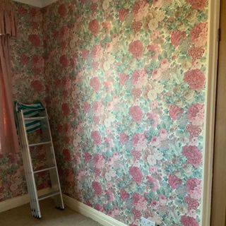 before makeover with floral wallpaper and ladder