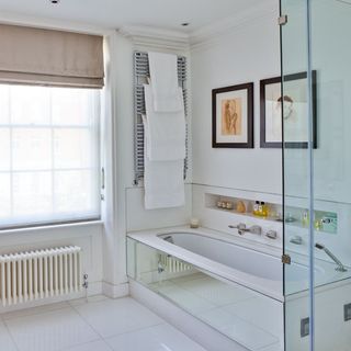 bathroom with bathtub and white towel rack