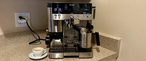 Front of Ninja Luxe Café coffee maker with cup of espresso