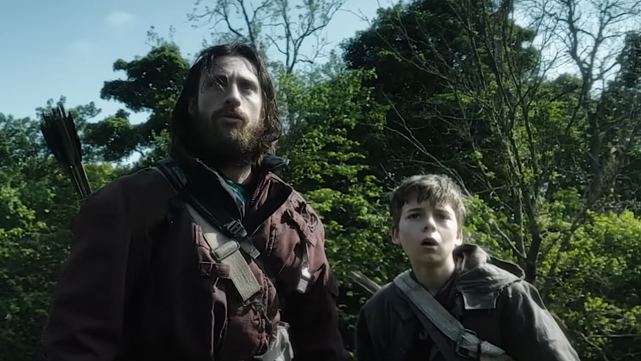 Jamie and Spike staring ahead in shock while on the mainland in 28 Years Later