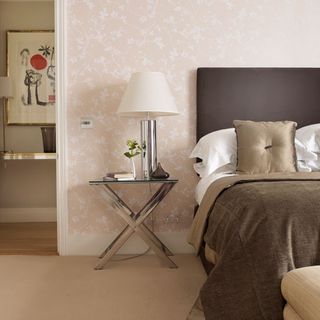 bedroom with peach wall and brown bedding