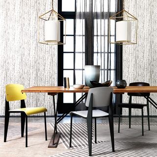 dining area with textured wall and dining table and chair
