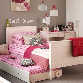 childrens room with stowaway trundle bed and white furniture