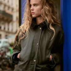 Woman wears the Zara waxed jacket