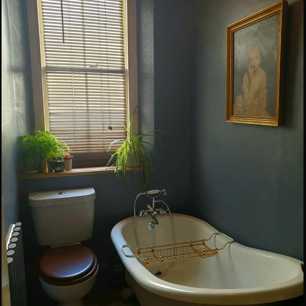 bathroom with bathtub and commode