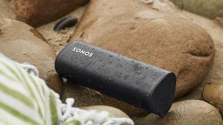 The Sonos roam Bluetooth speaker on a piles of rocks 