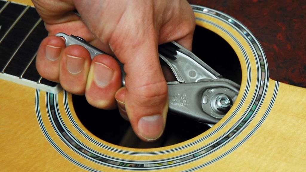 Guitar setup how to remove bridge pins on an acoustic guitar MusicRadar