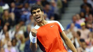 Tennis player Carlos Alcaraz of Spain, wearing a red Nike top, pumps his fist in celebration ahead of his debut at the ATP Finals 2023