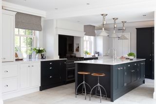 Shaker kitchen with black and white cabinetry and quartz countertops
