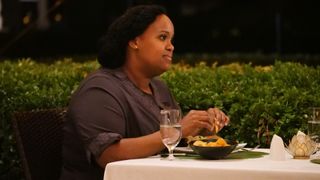 Natasha Rothwell dining outside in The White Lotus