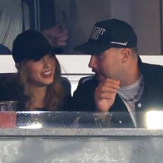 Taylor Swift and Travis Kelce sit in box seats at the Yankees vs. Guardians game where both stars wear black baseball and black jackets