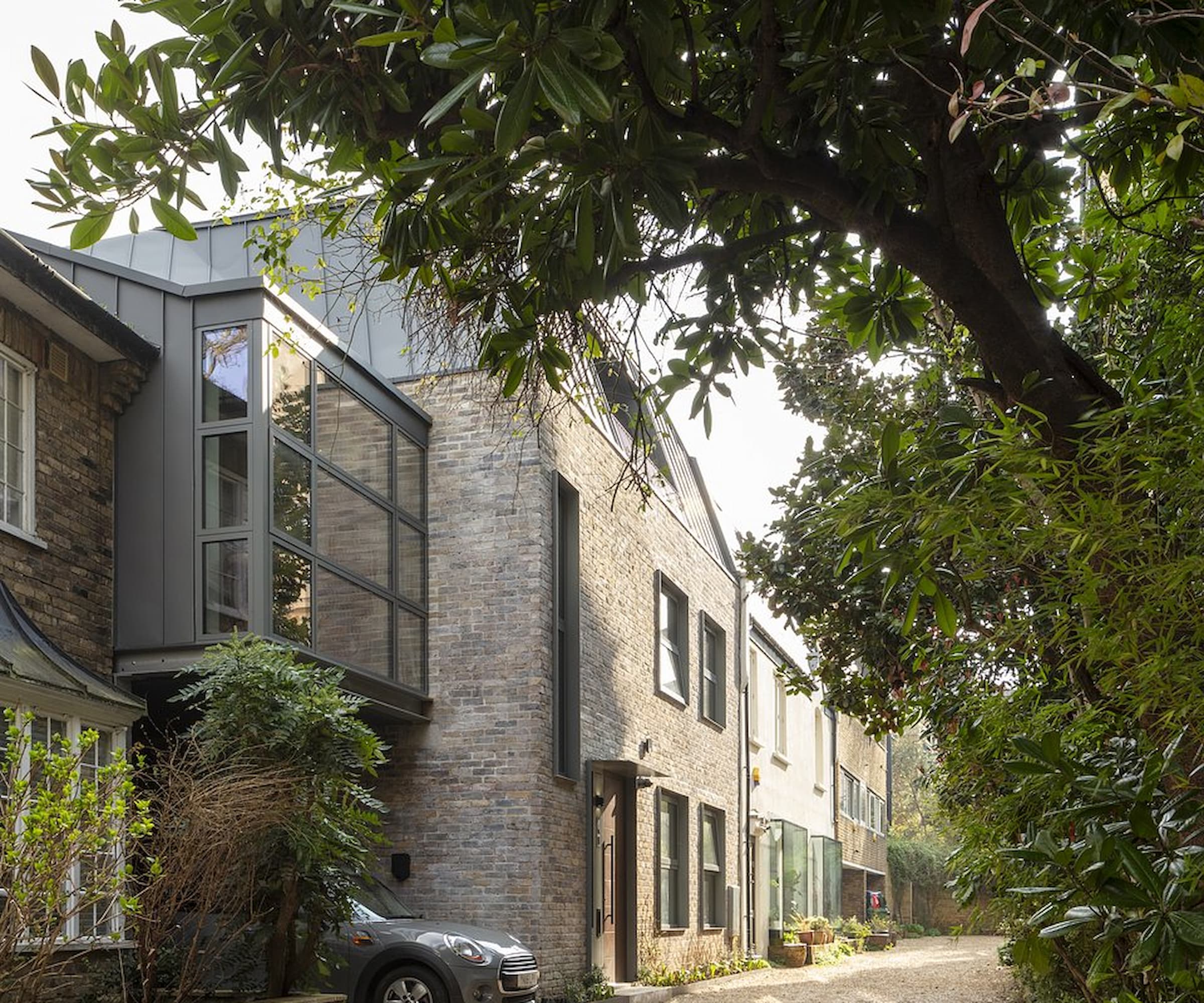 A townhouse with a side extension and a third-floor extension