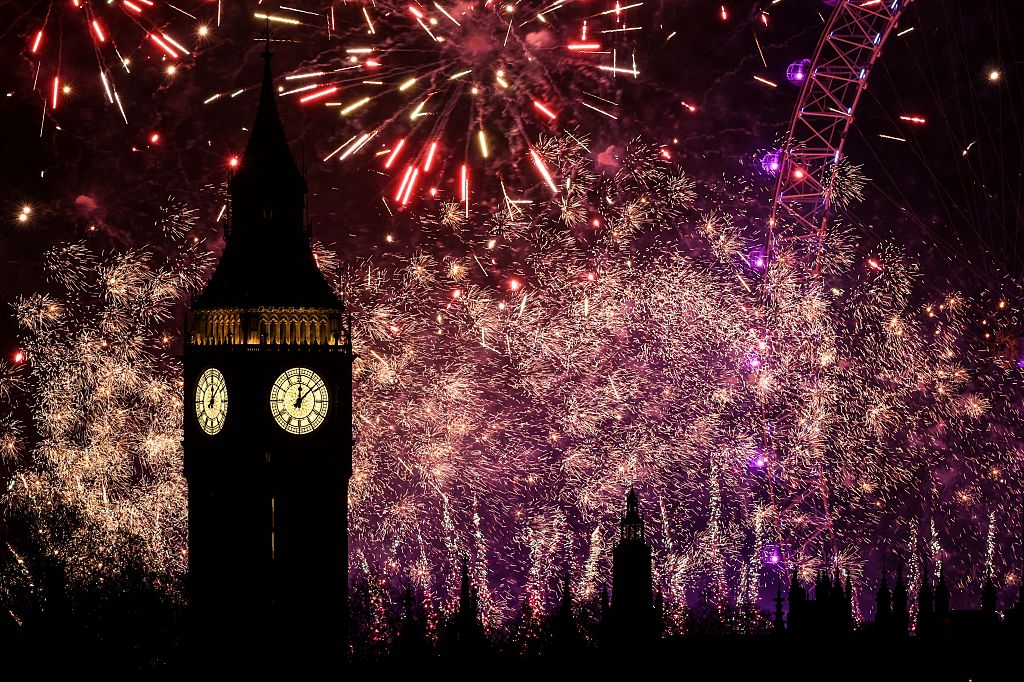 Fireworks explode in the sky around the London Eye and The Elizabeth Tower