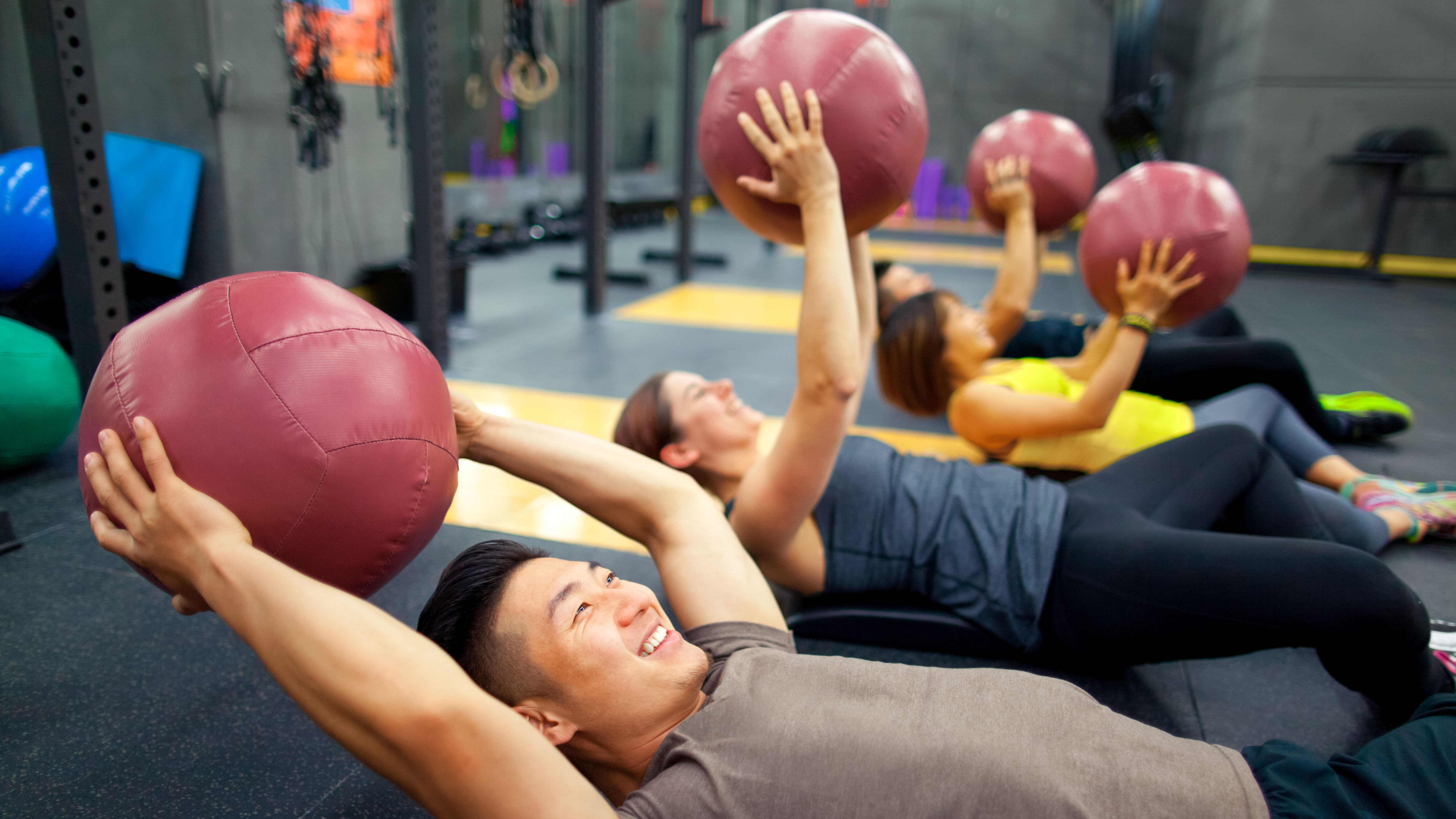 Group of people using exercise balls in class
